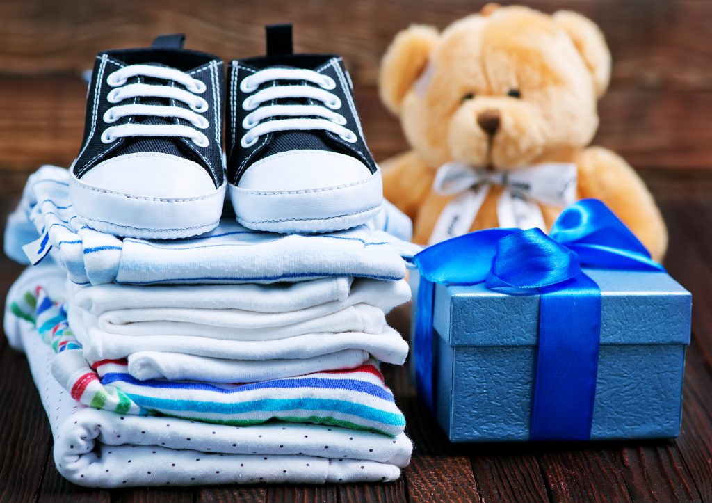 a stack of baby clothes - ways to make money online