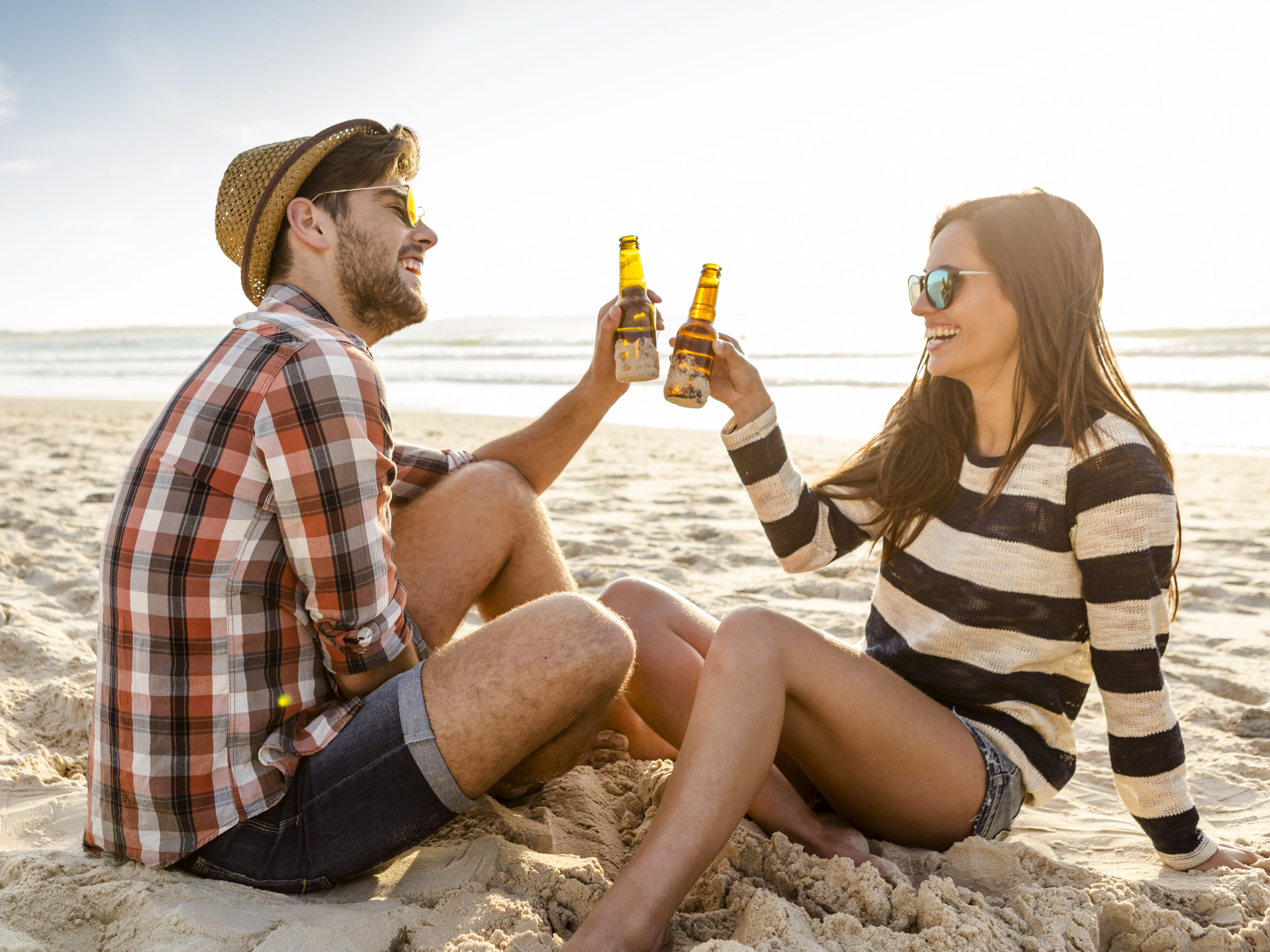 Couple having a date on the beach, after researching UK Summer Date Ideas.