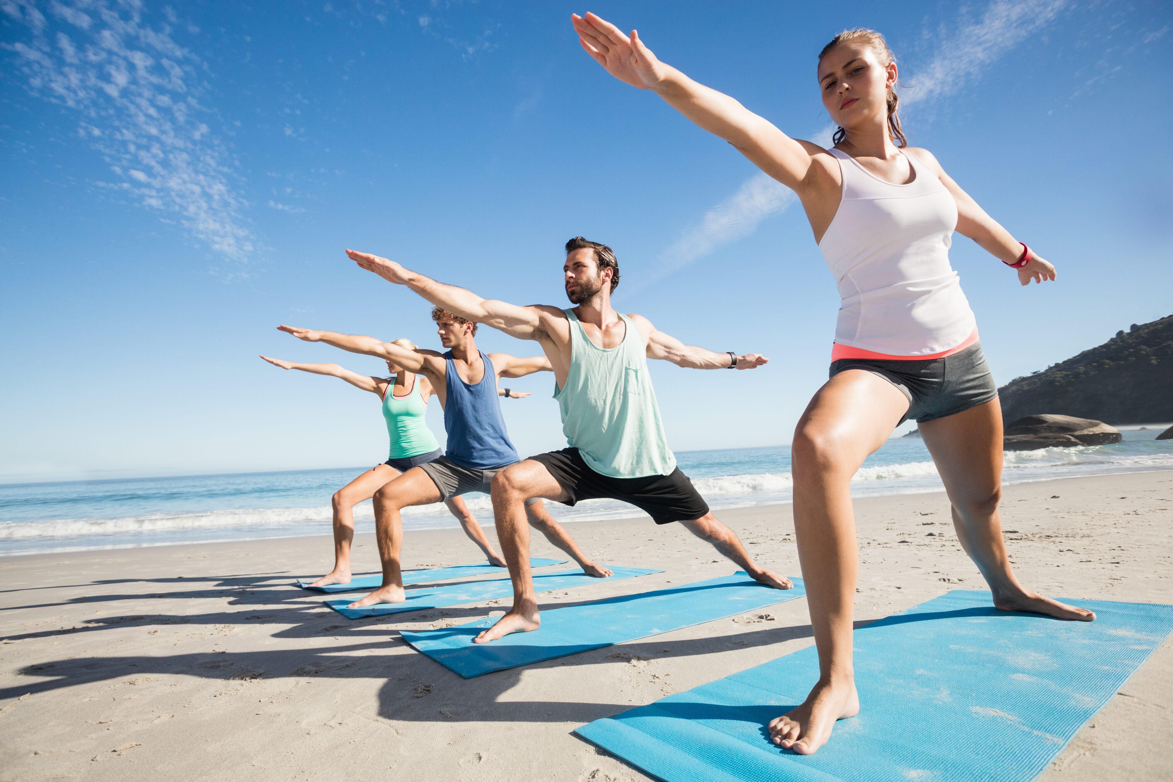 People doing yoga on El Cotillo Beach - a must when looking into Fuerteventura Caravan holiday ideas