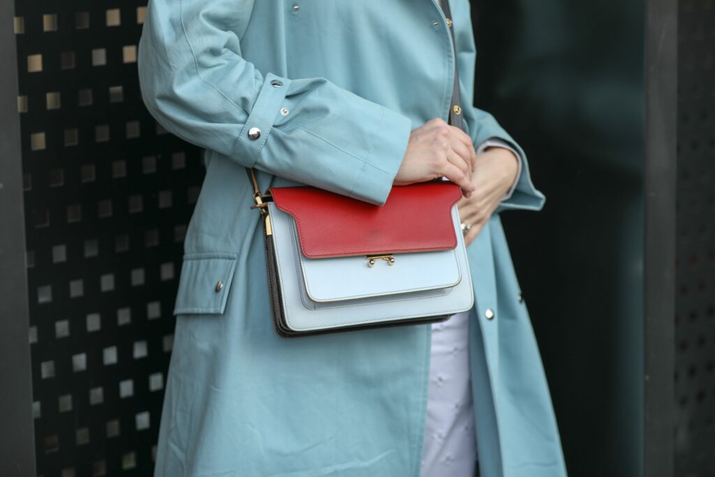 Woman dressed in a warm coat, with a leather bag who spent time finding the right bag for winter